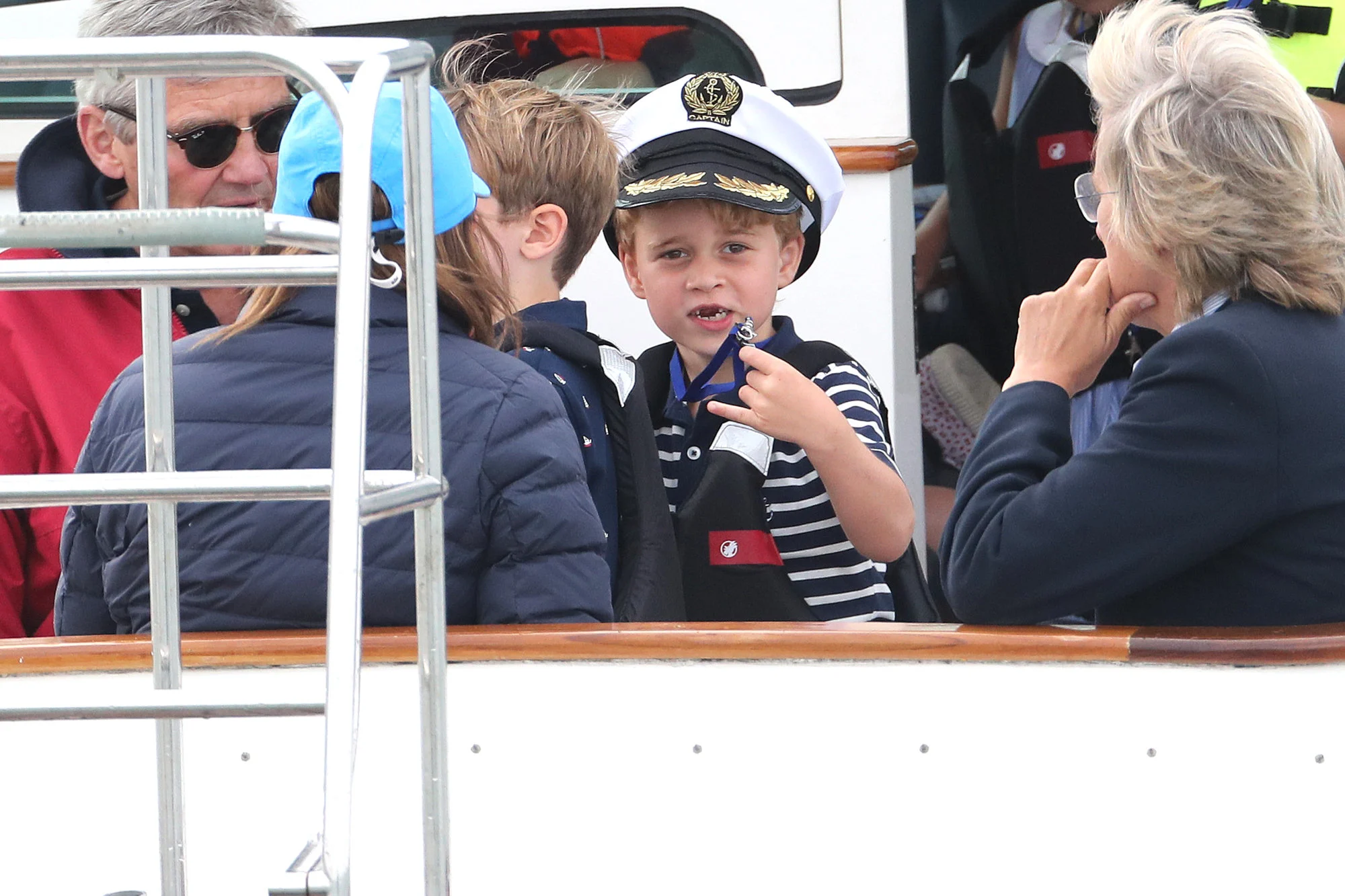 Prince George was watching his parents race from a nearby sailboat, chaperoned by his maternal grandfather, Michael Middleton.
