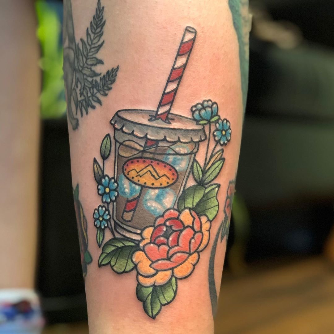 A male barista with a tattoo pours fresh milk into a glass with ice and  coffee Cooking summer drink a man with a tattoo  CanStock
