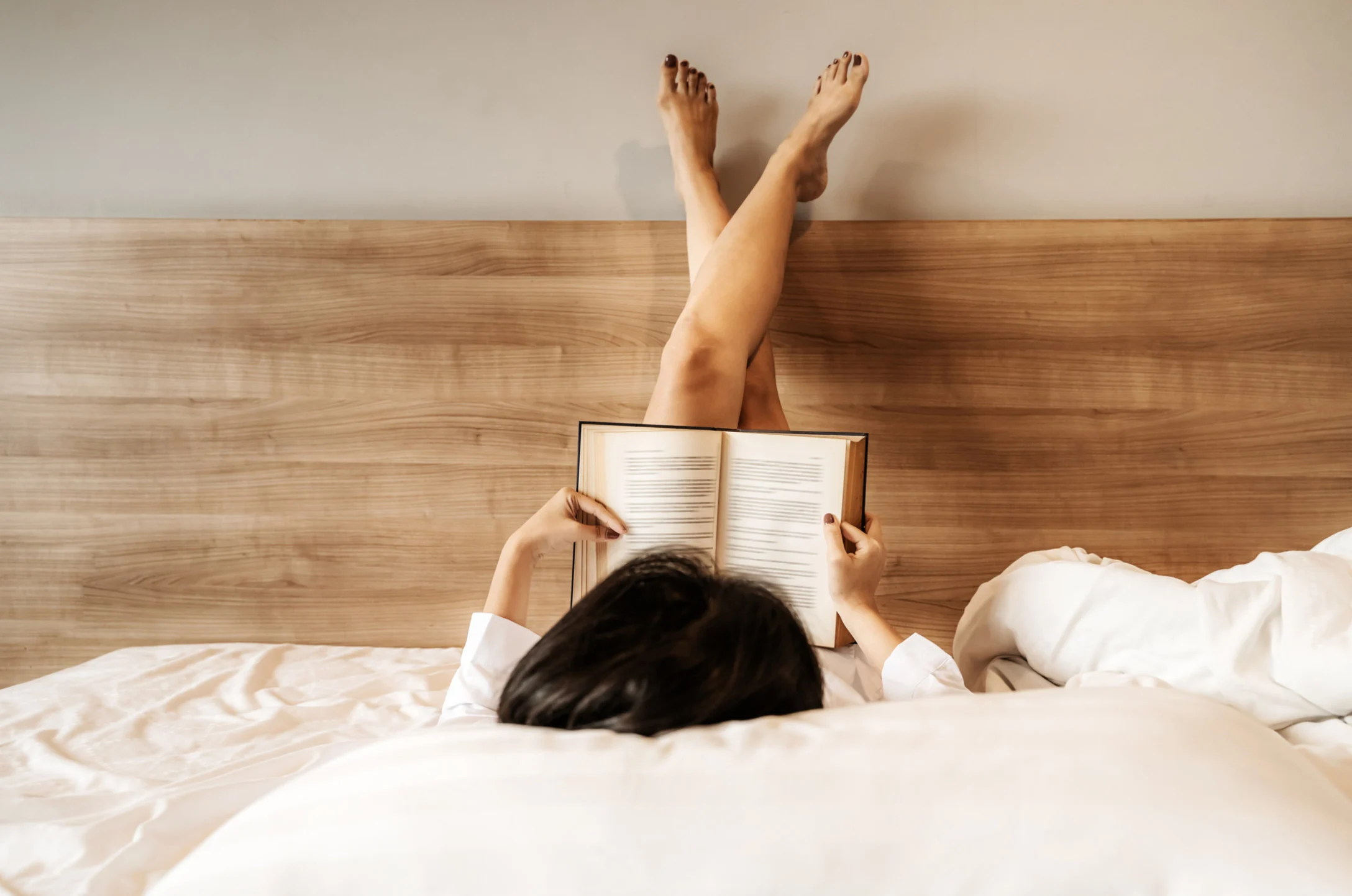 Woman in bed reading