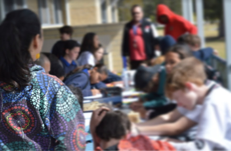 29 August 2019 - Batemans Bay New South Wales - A mentor works with mentees at an AIME program day at the University of Wol