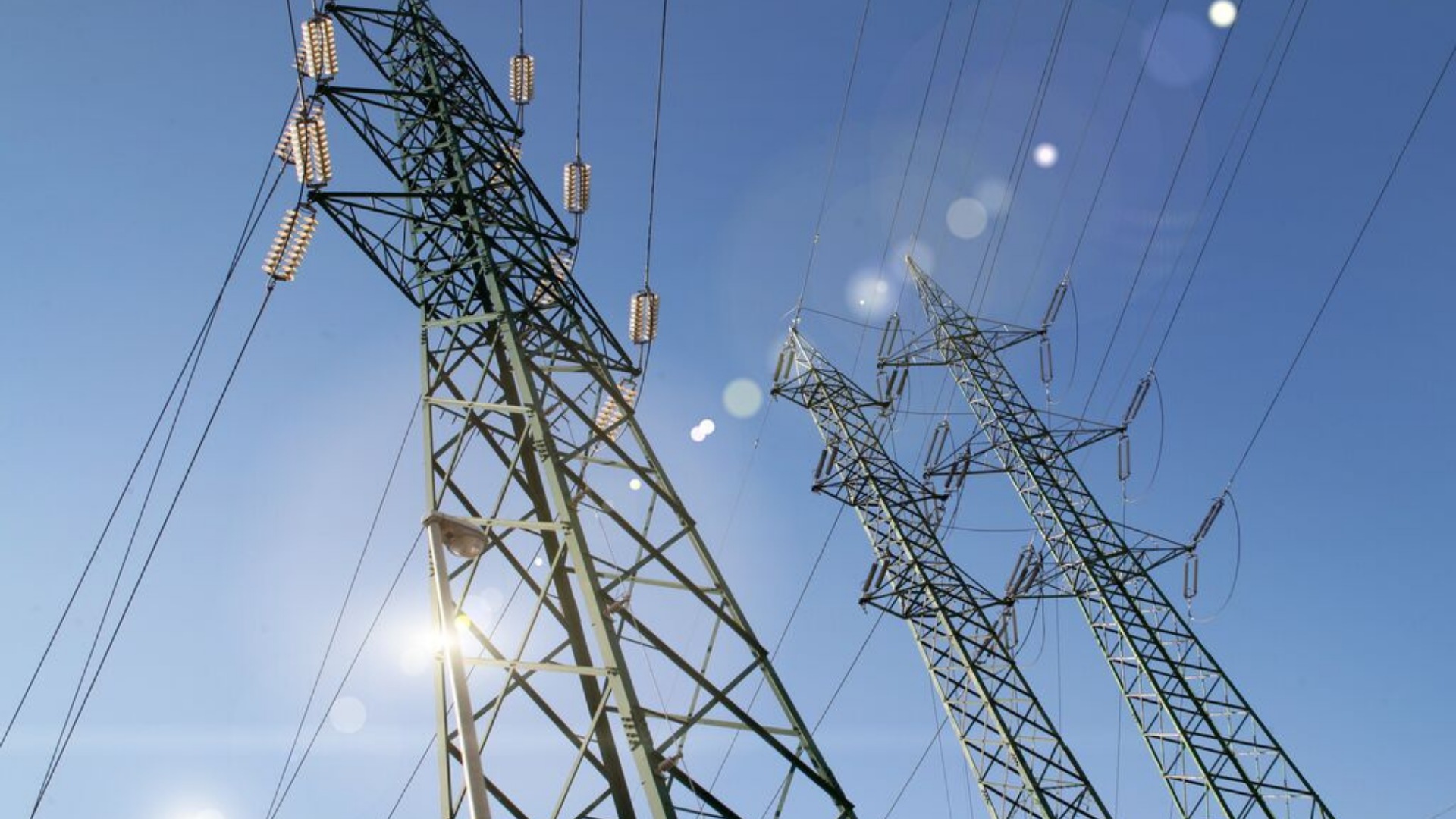 UK electricity pylon distributing power to businesses and homes. card