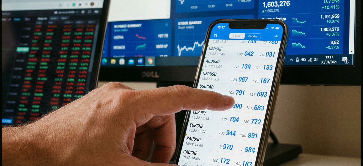 Person checking exchange rates on a phone and setting a target rate for an international money transfer, with simple charts in the background.