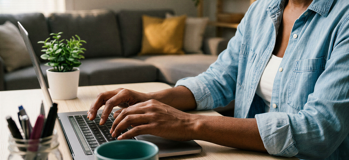 Finance lead reviewing an accounting dashboard on a laptop, with invoices, bank feed matches, and expense categories visible on screen, notebook and coffee on the desk.
