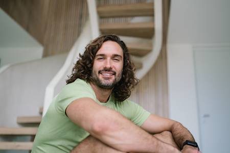 Joe smiling to camera wearing a green top