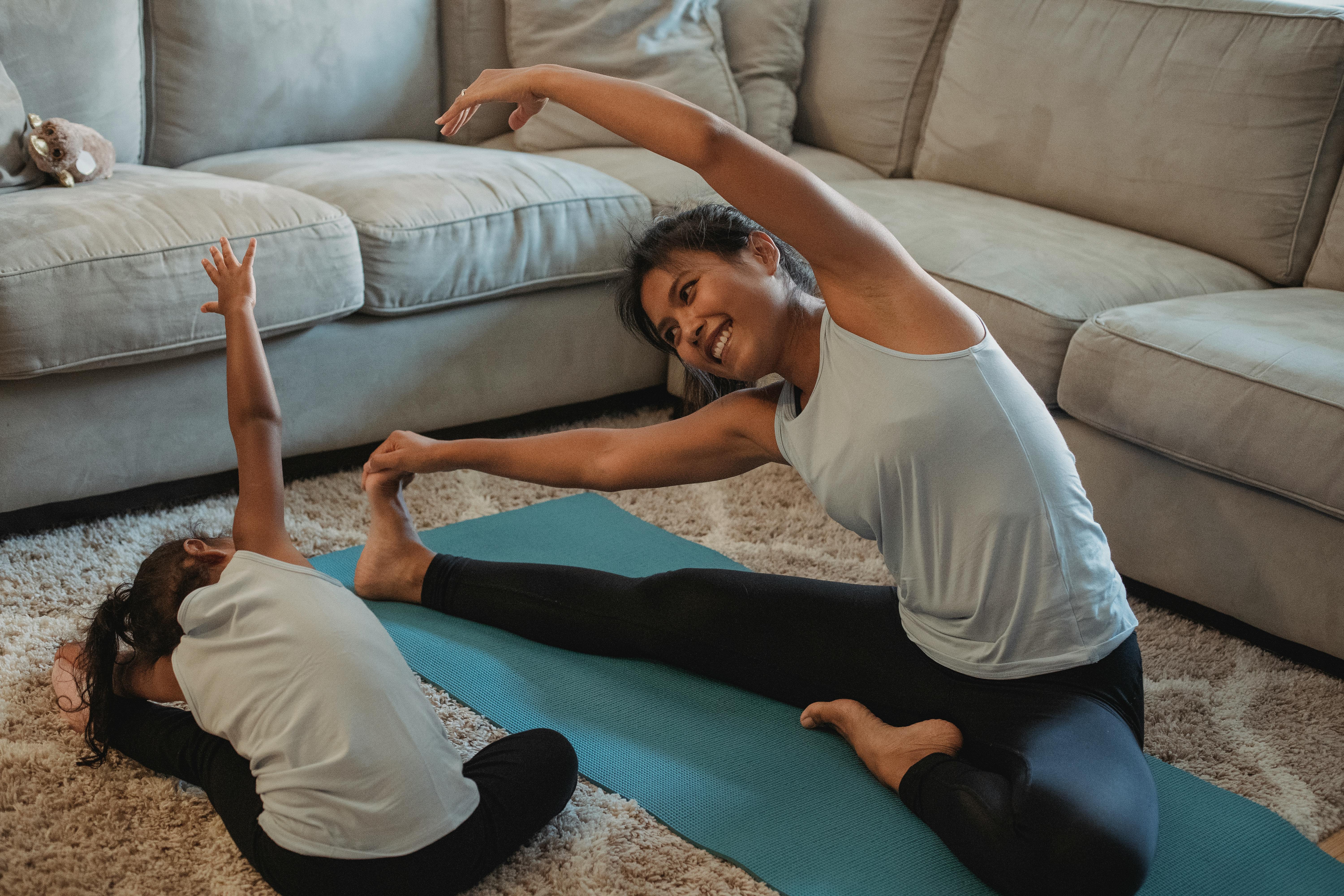Woman exercising with her daughter yoga