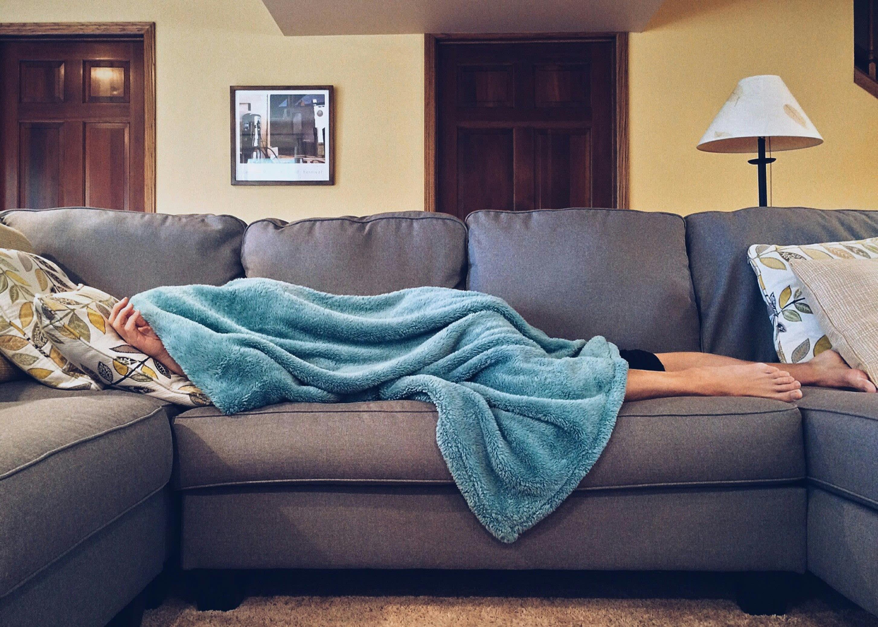 Woman on sofa struggling with motivation