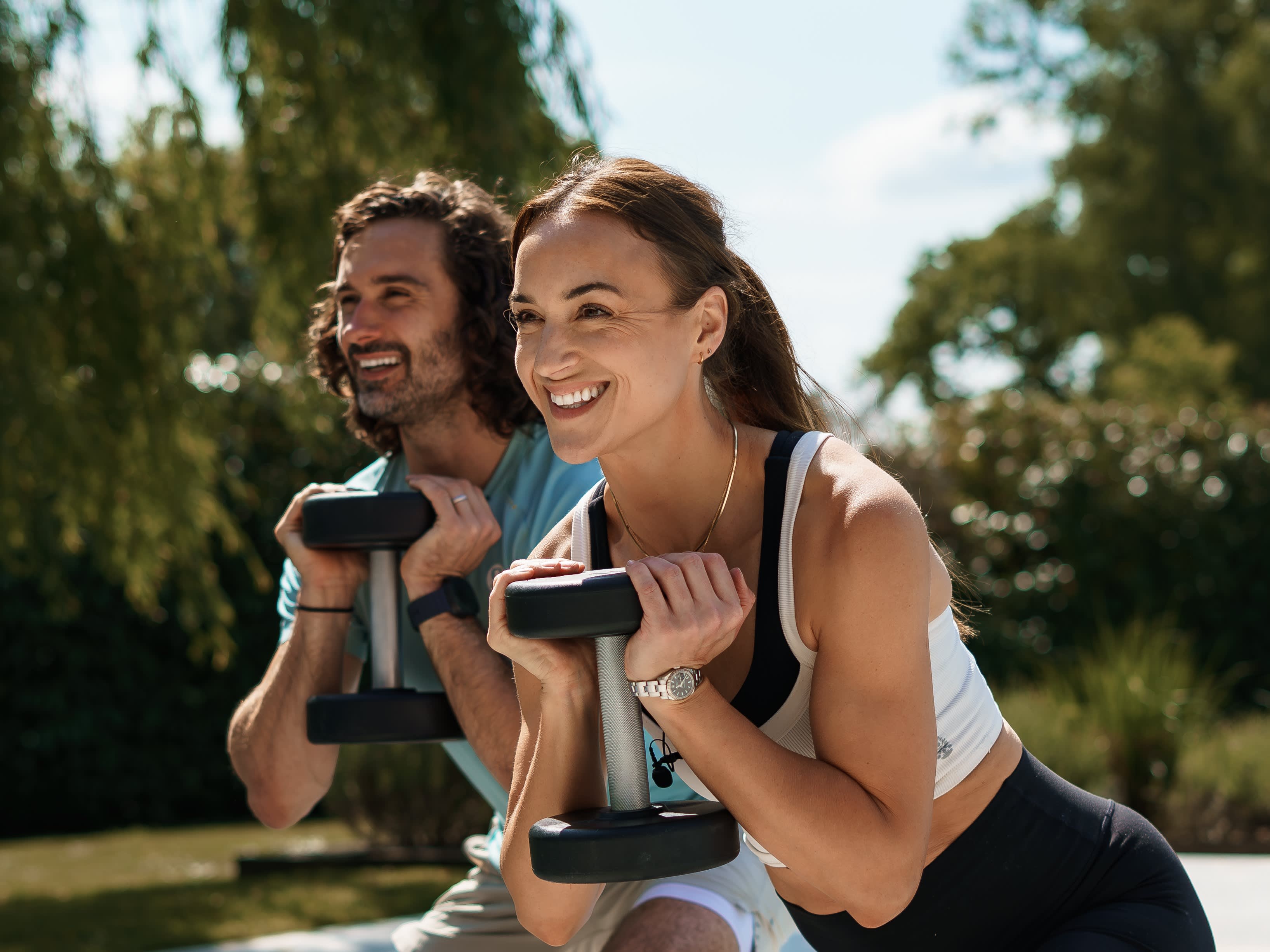 Joe and Rosie holding weights smiling