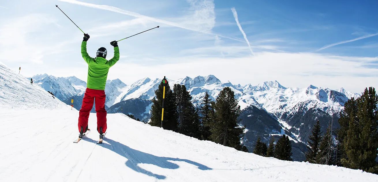 Skier rejoices in the sunshine at the ski resort