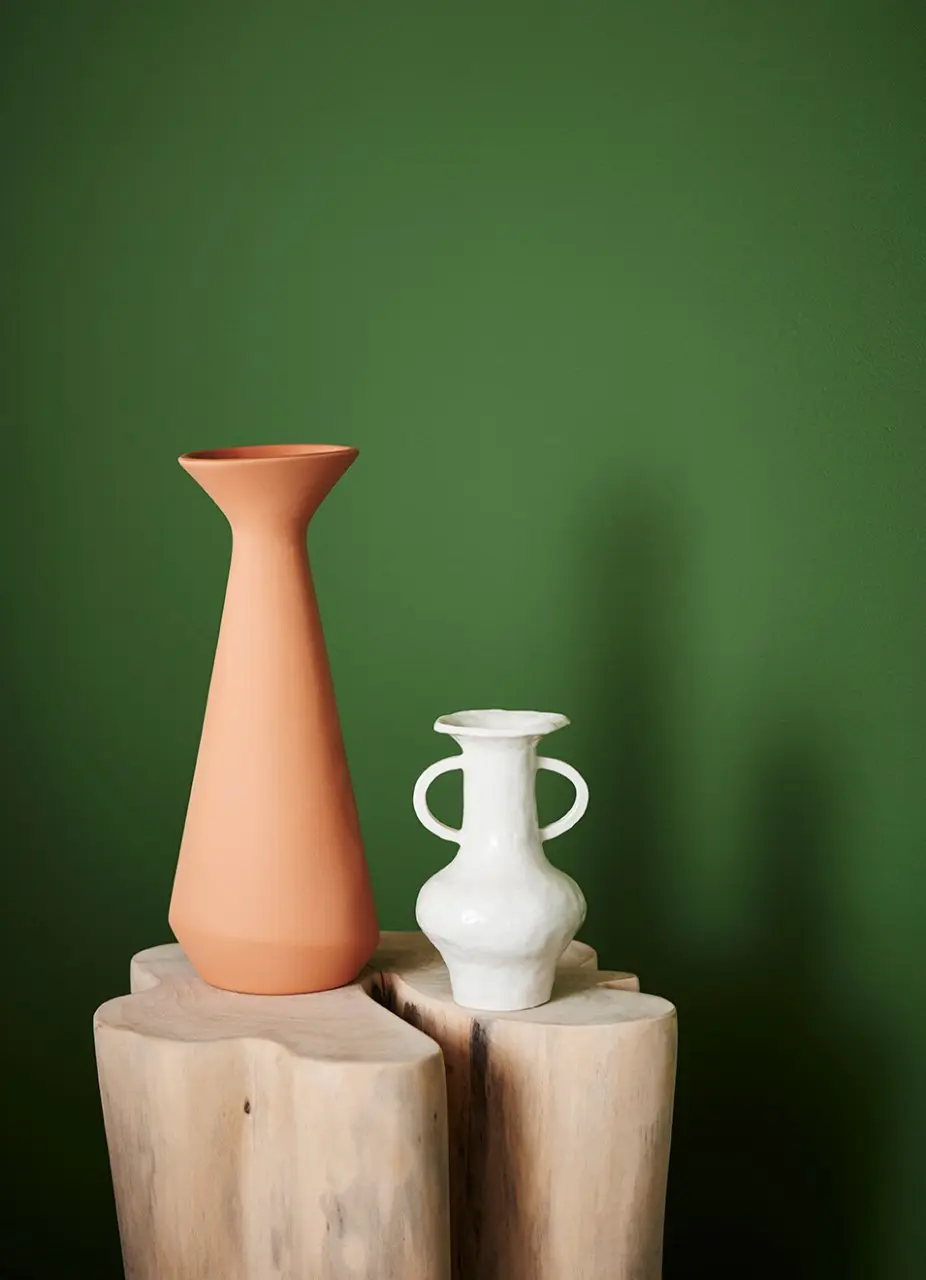 interior decor green wall and pink vases.