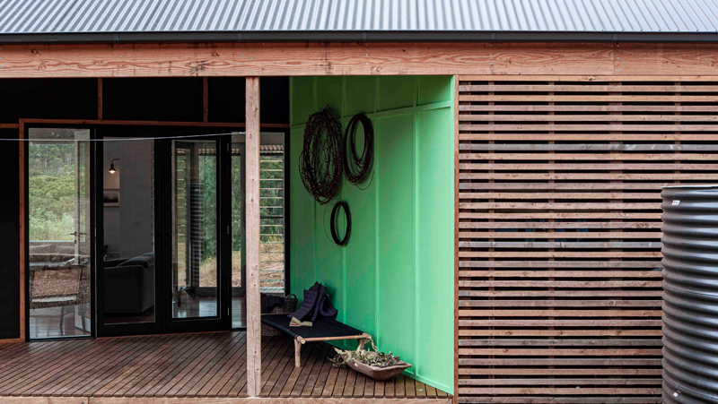 Timber building with green feature wall.