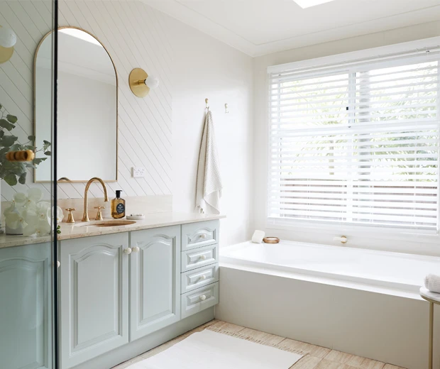 view of cream and pastel green bathroom 