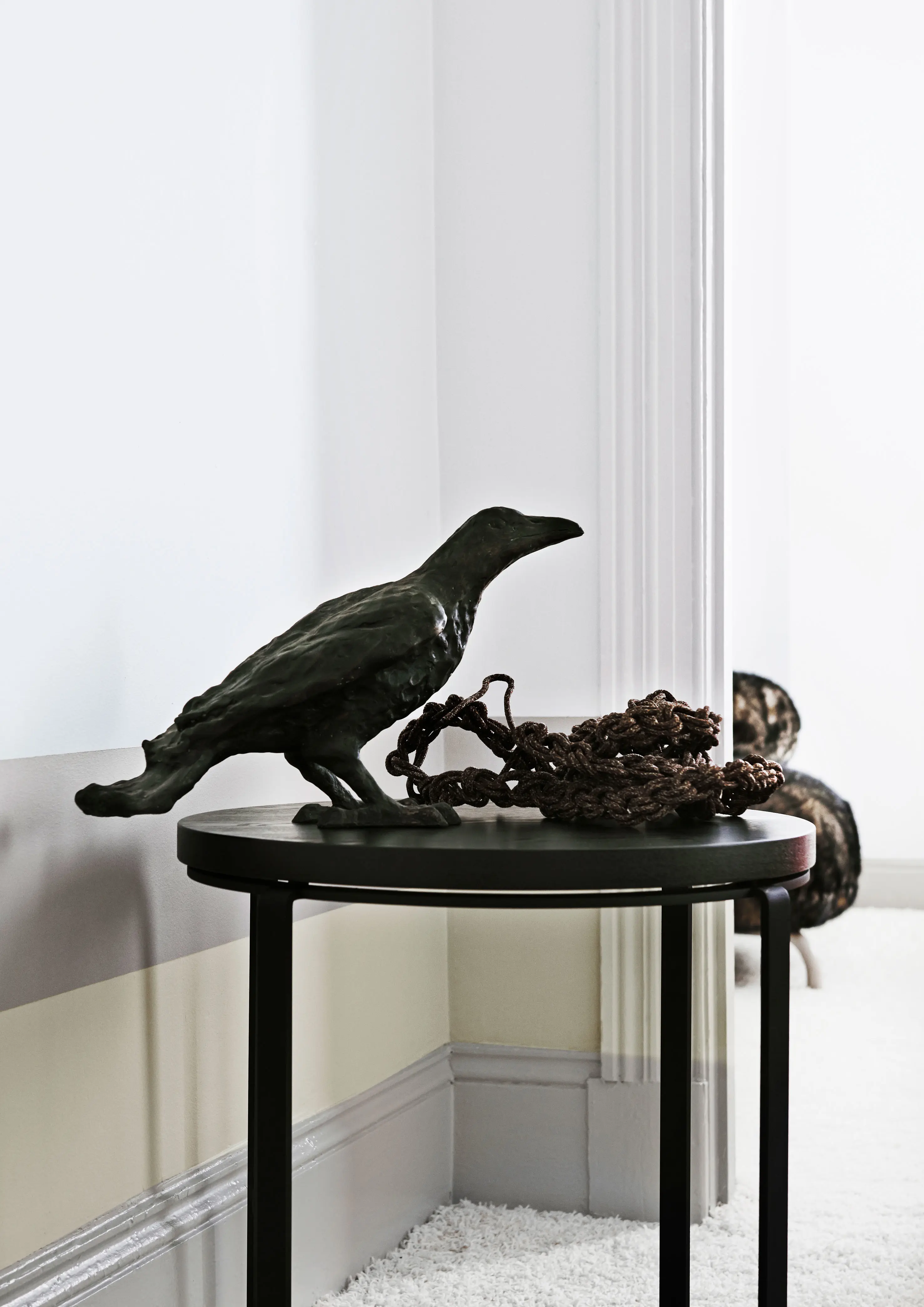 Black crow statue on black table