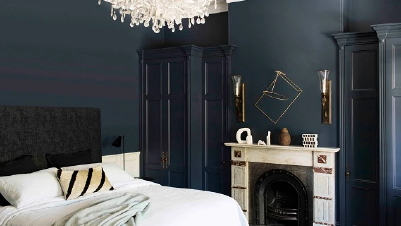 Black bedroom with white marble mantle