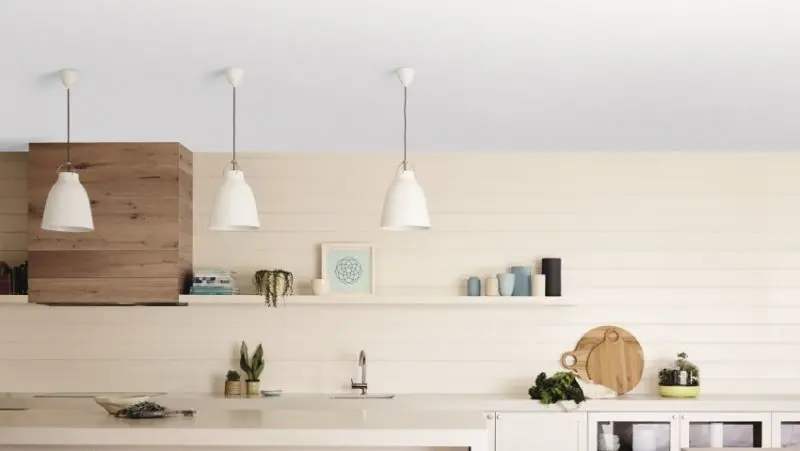 White kitchen ceiling and three white pendant lights