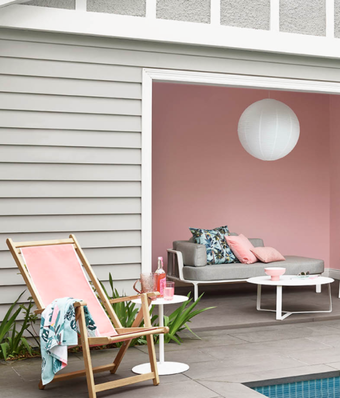 view of pink and white poolside seating 