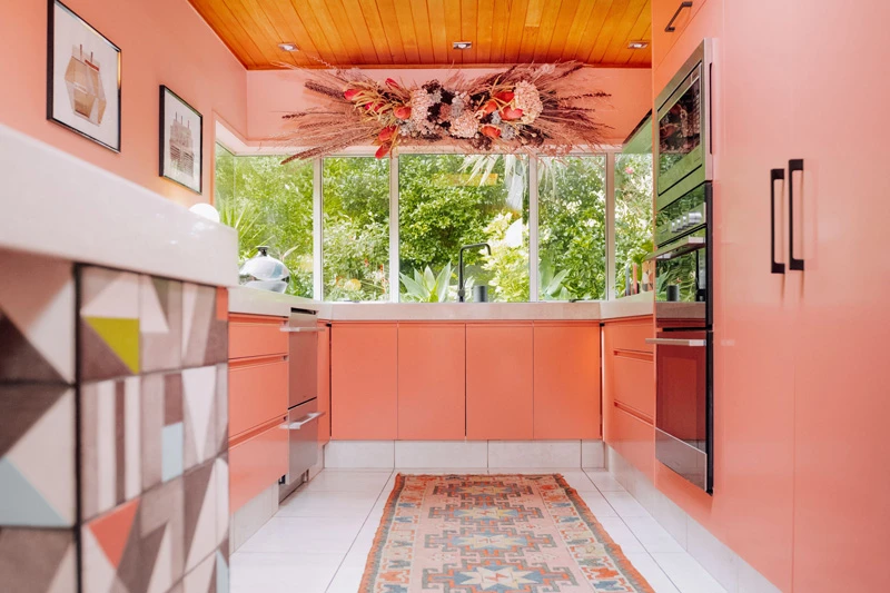 Low angle of Evie Kemp's pink kitchen painted in Dulux Renovation Range