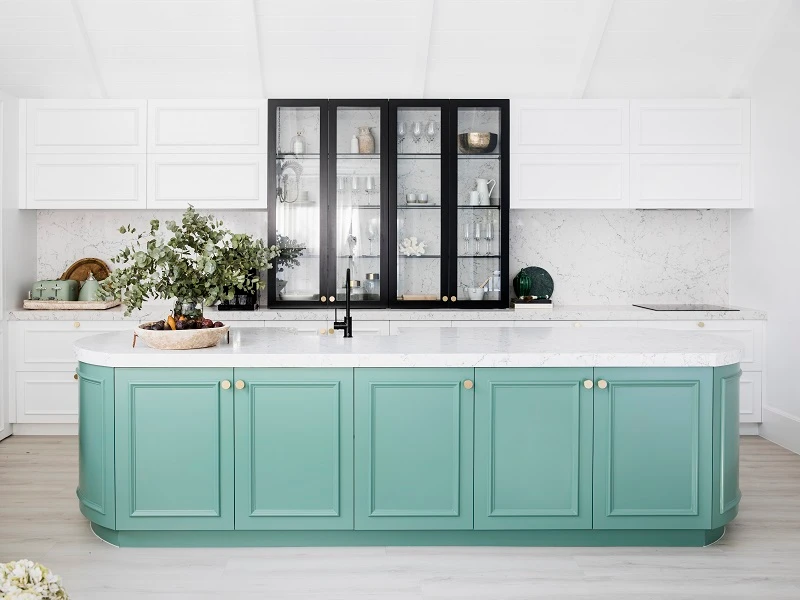 Kitchen with a white bench and cabinets and pastel green cupboards