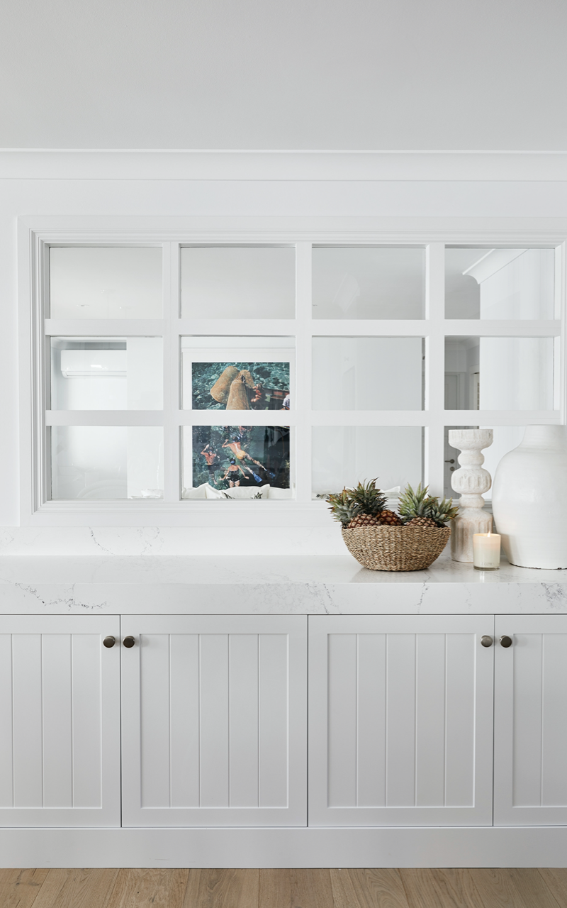 Airy kitchen nook featuring bright white cabinetry