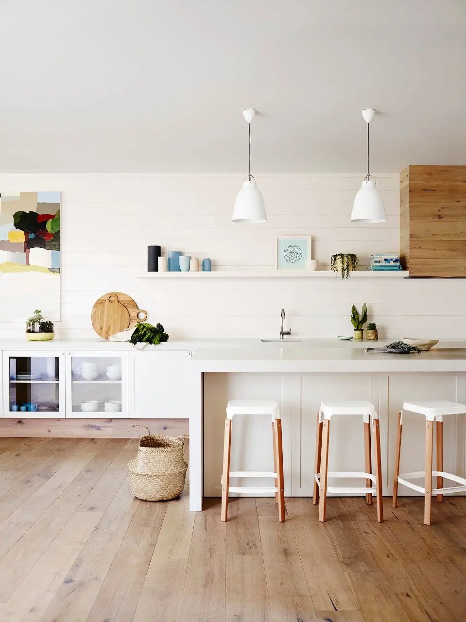 Kitchen with island bench and tall stools up against the breakfast bar
