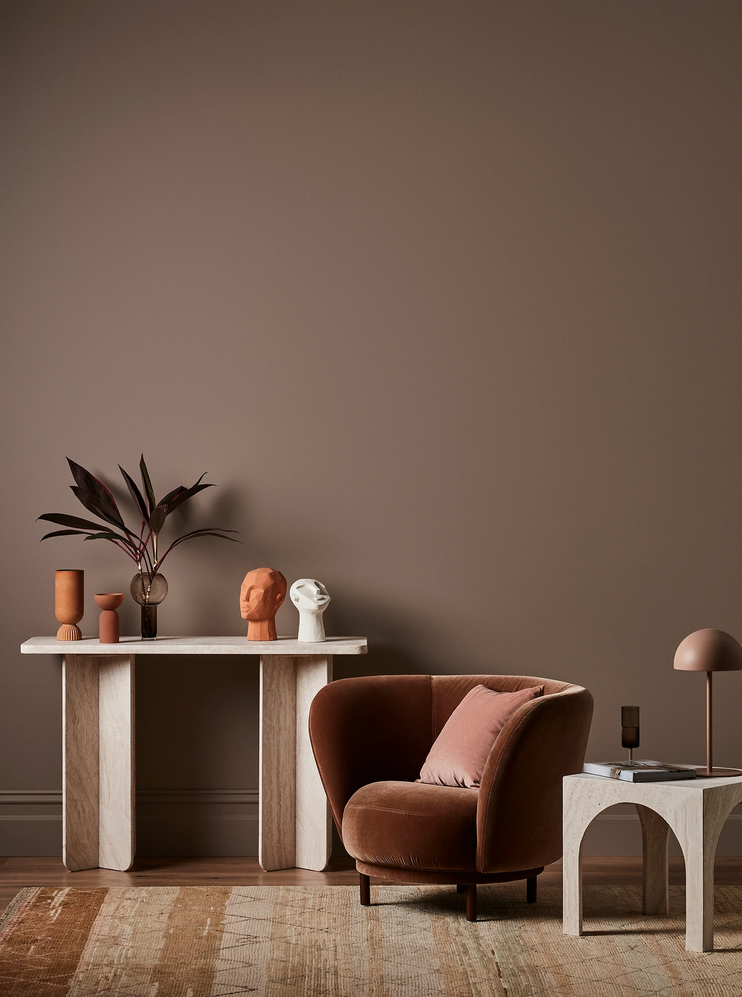 Brown living room with tables and brown velvet armchair.