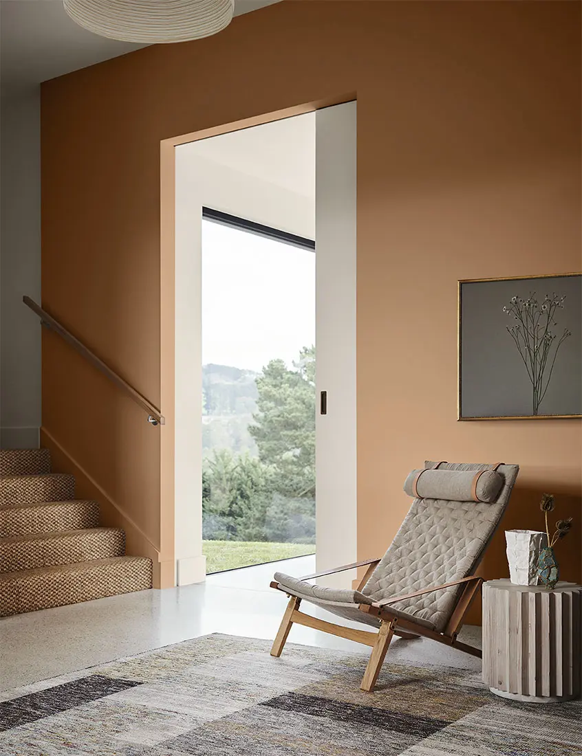 Living room with orange walls and relaxed arm chair