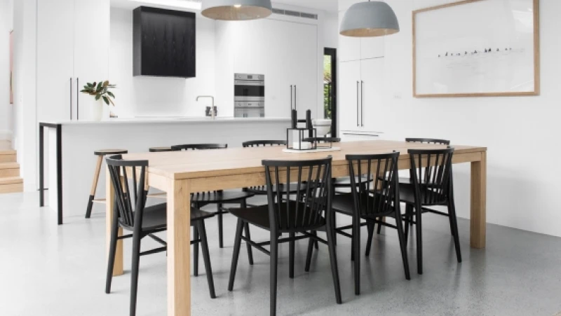 White kitchen and dining room with timber table