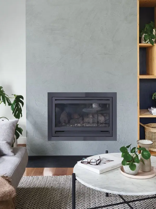 Living room with grey textured fireplace and marble coffee table