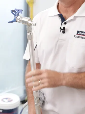 Close up of spray gun with extension