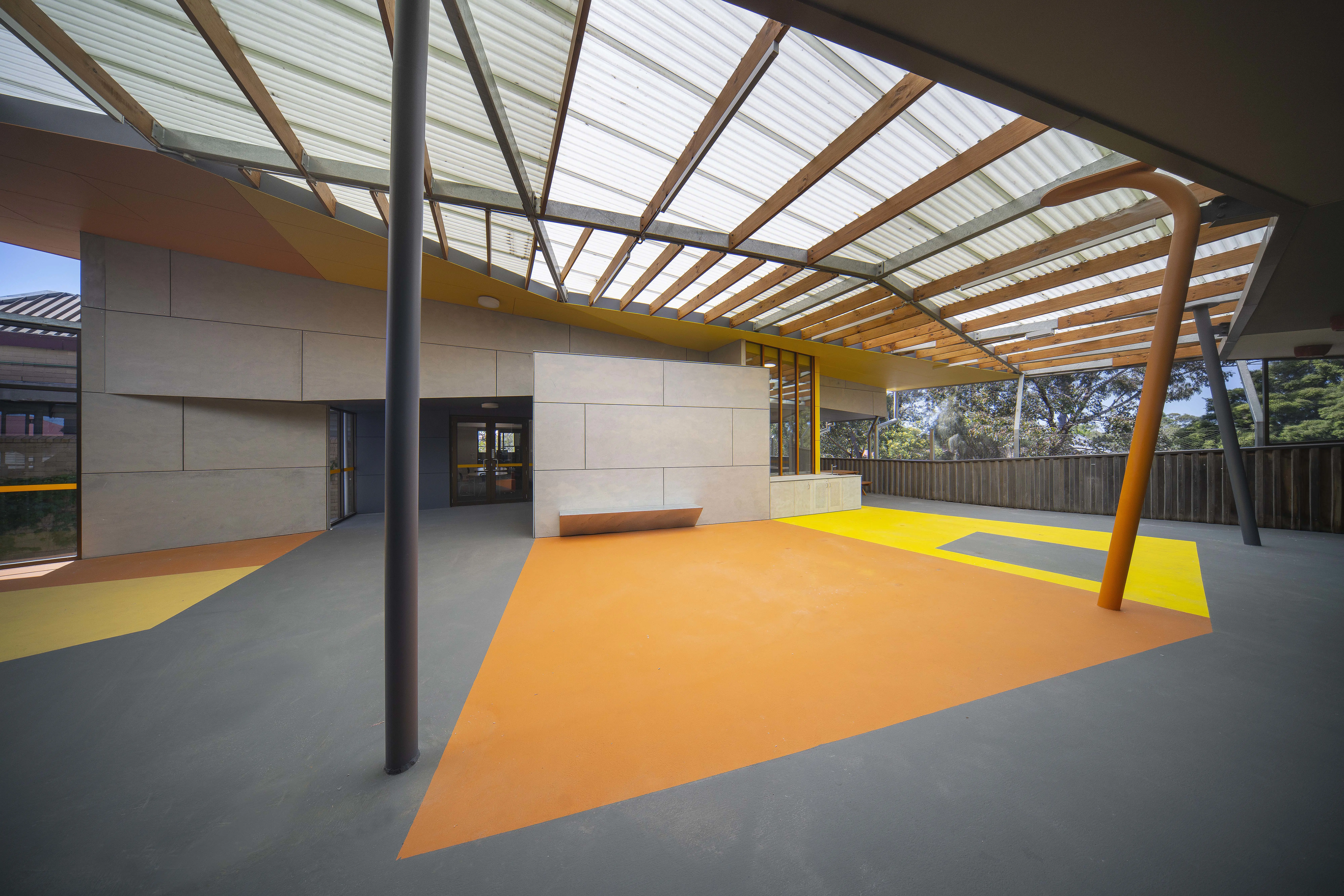 Undercover play area with orange, yellow and grey floor