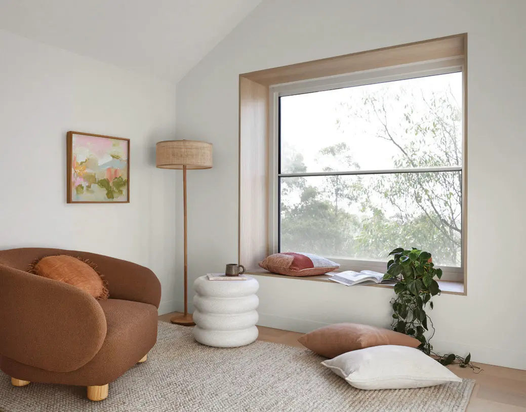 interior white lounge room with hanging chair in the corner