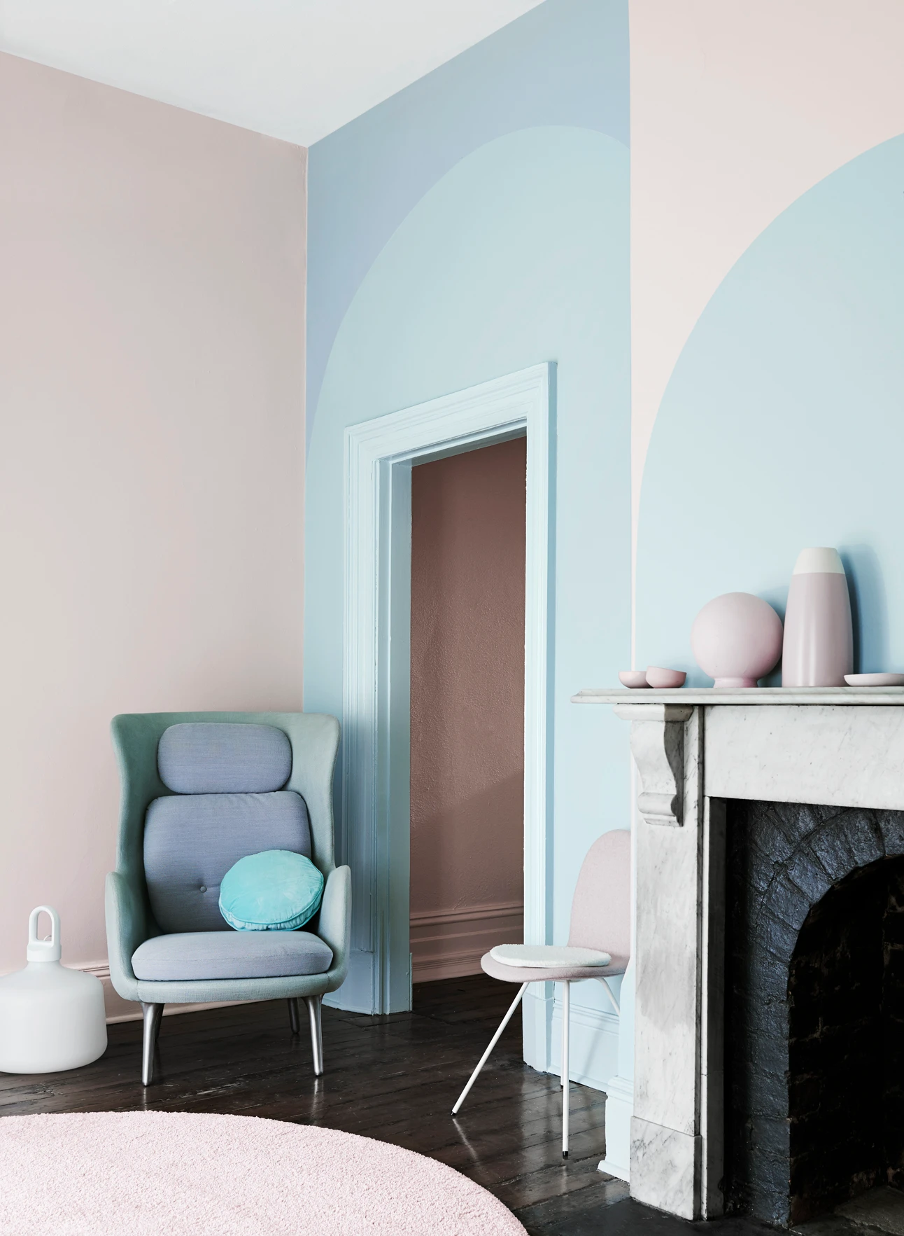 Blue and pink room with traditional fireplace.