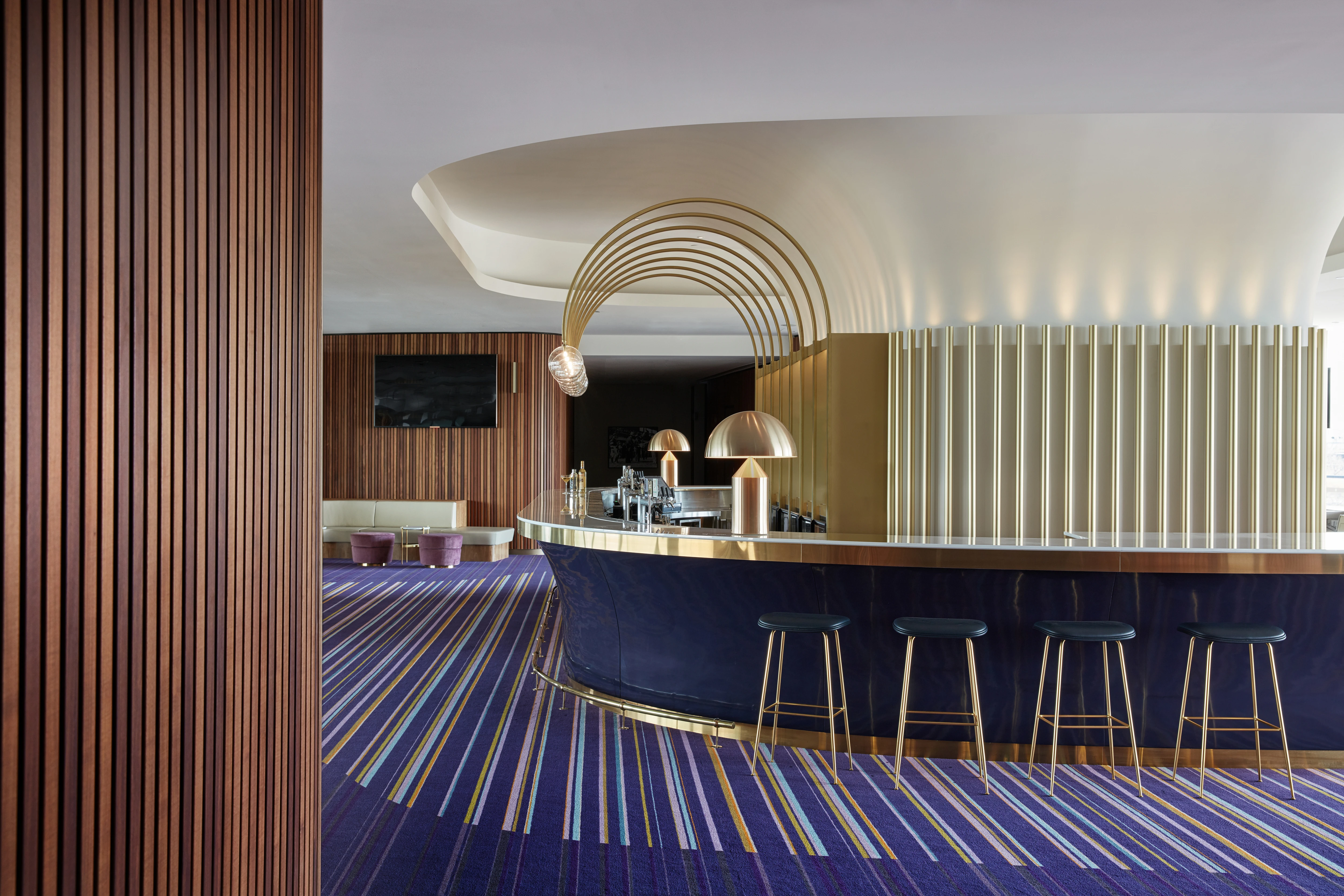 Gold, white and deep purple bar and stools with purple carpet 