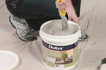 Stir contents of Dulux Texture Medium Cover™