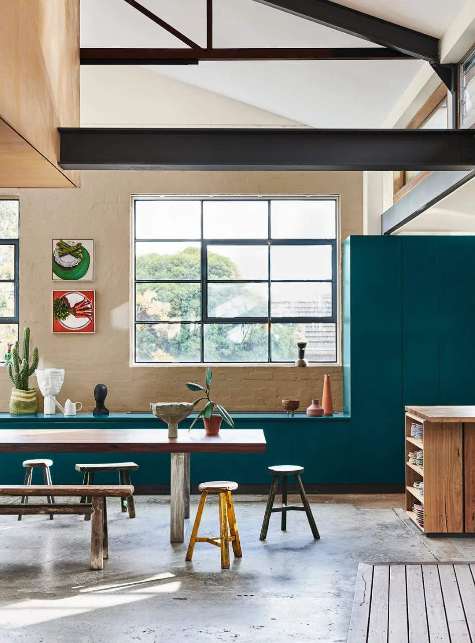 interior teal kitchen with table and stools.