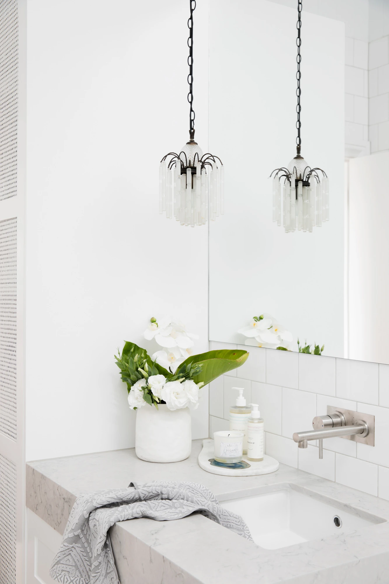 white bathroom with marble vanity and two crystal pendant lights, Bonnie's Dream Home by Three Birds Renovations