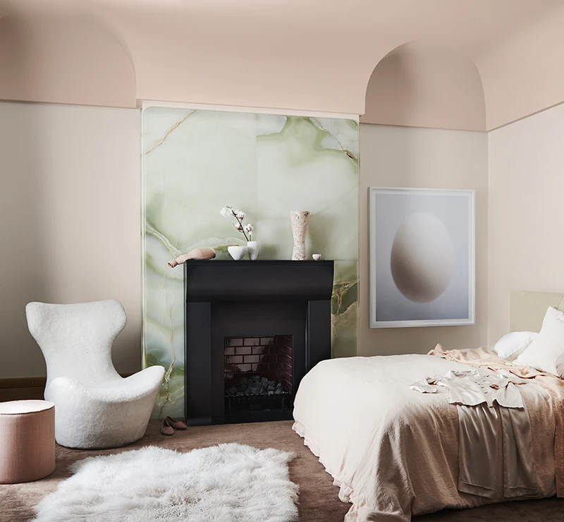 interior pink bedroom with fireplace.