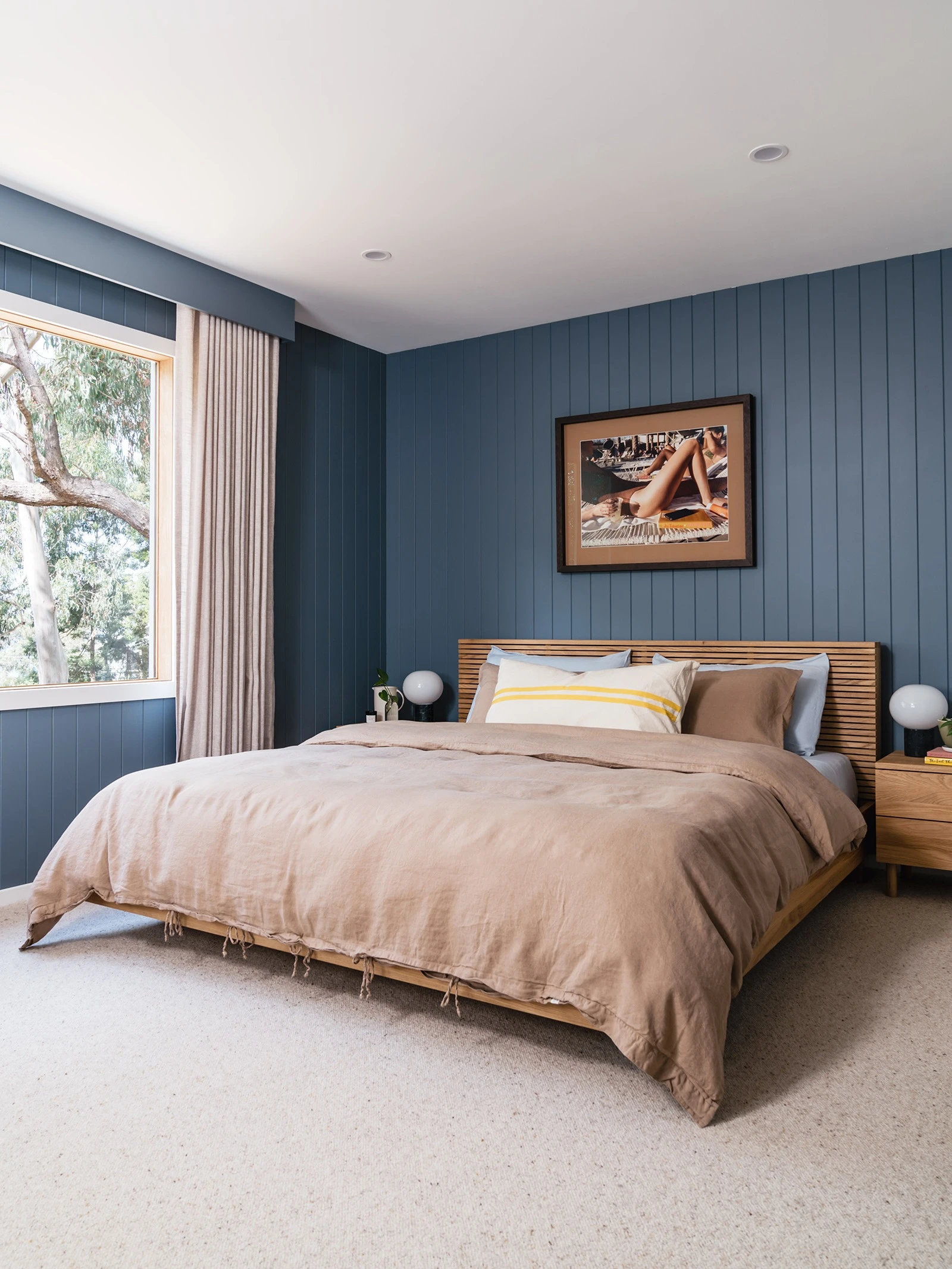 Guest bedroom with blue walls and white ceiling