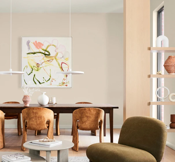 Neutral dining room with velvet armchair, timber dining table and chairs