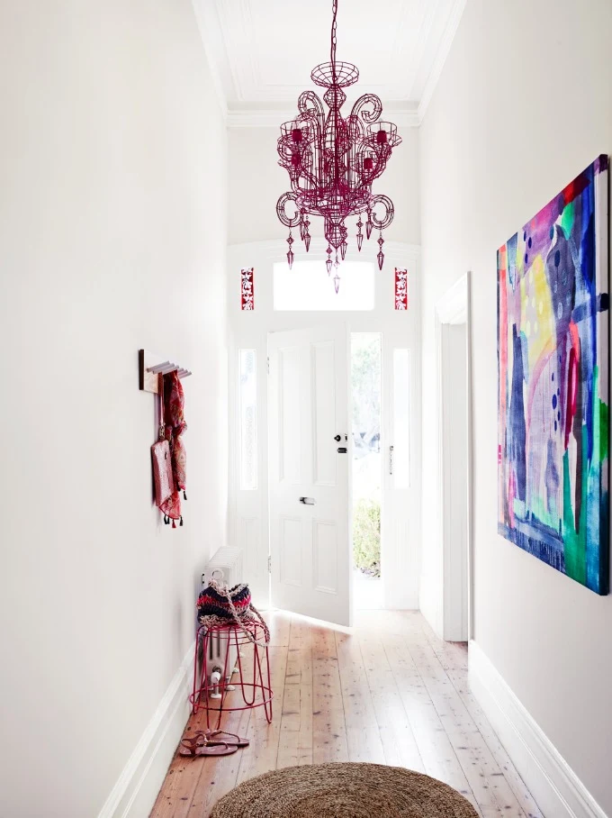 white hallway with chandelier feature