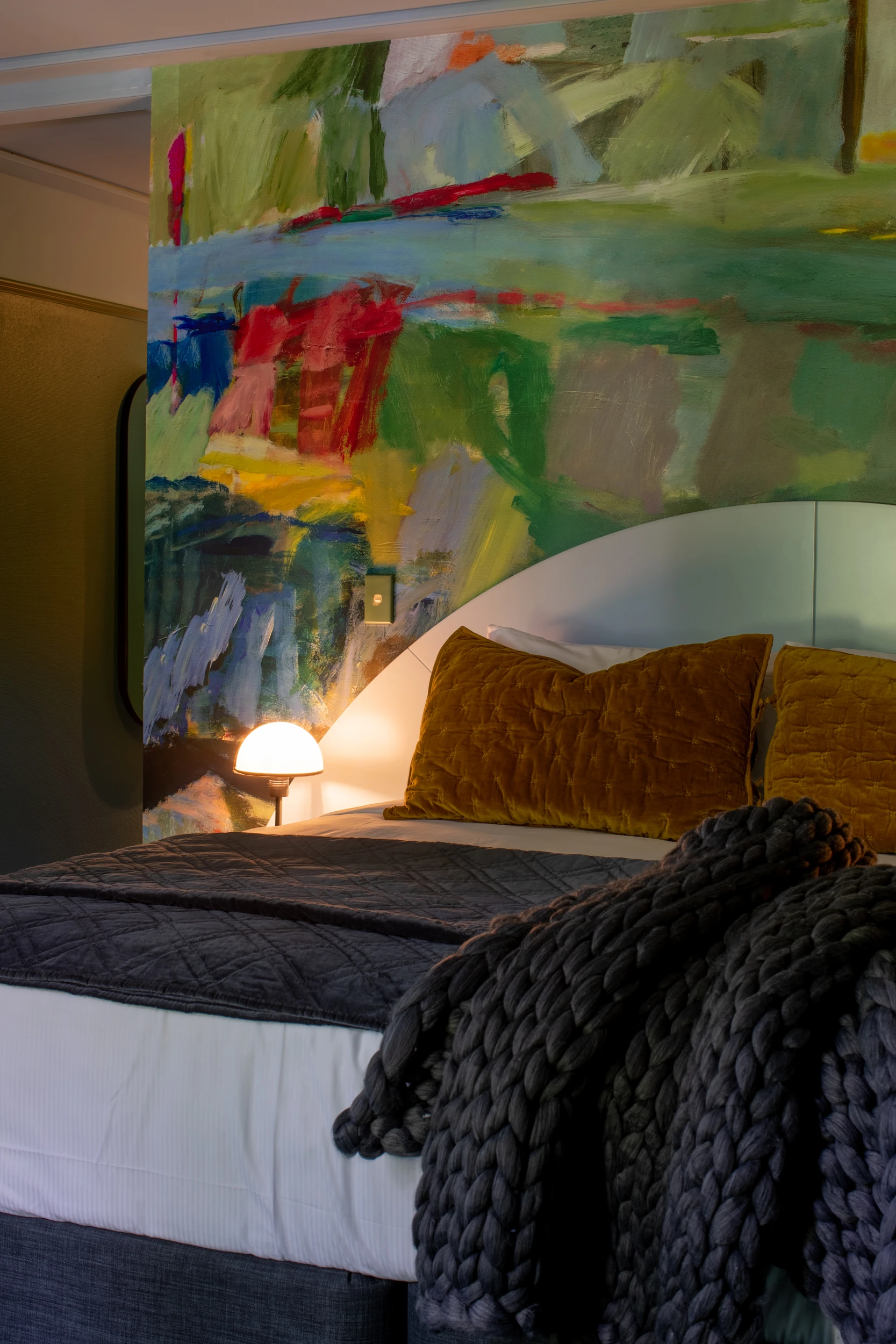 Bedroom with multicoloured feature wall.