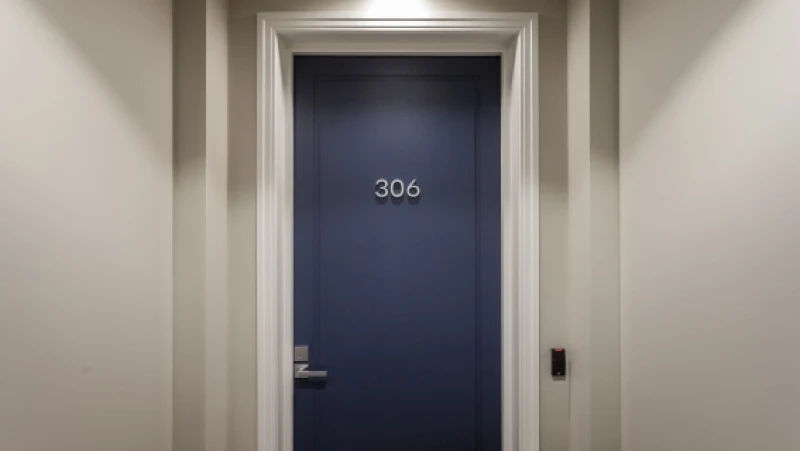 Blue apartment door with white trim and neutral hall walls