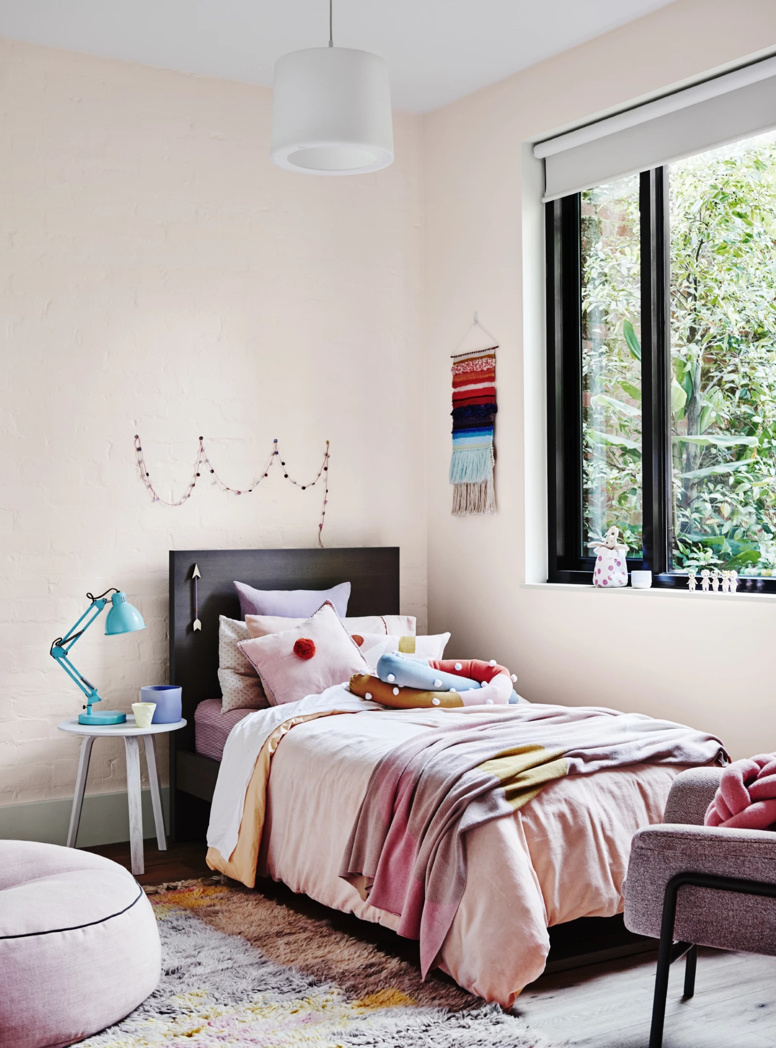 Kids room with pale pink doors and pink bedding