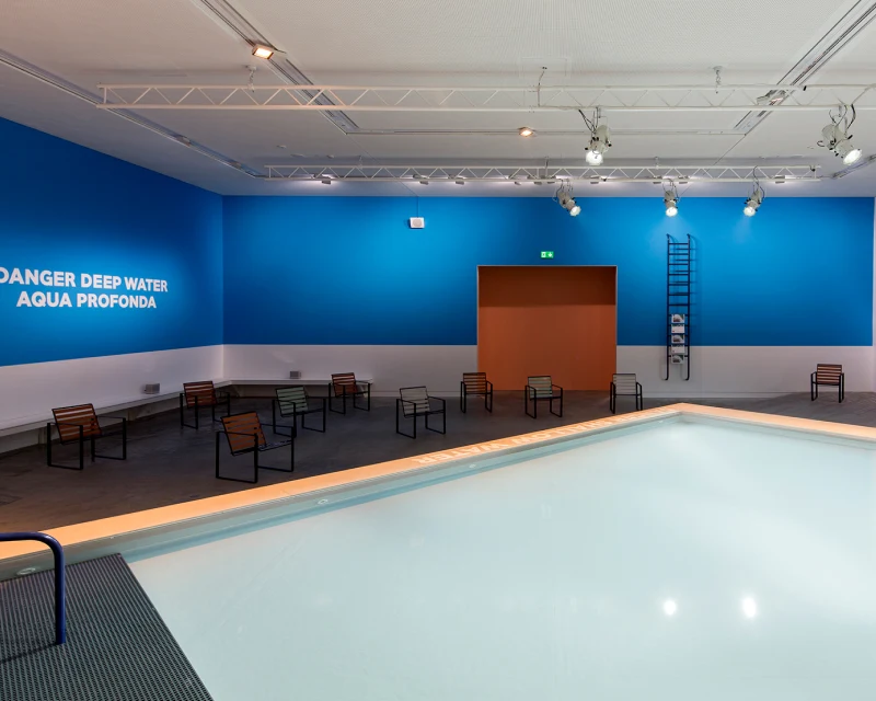 indoor pool with blue and white walls
