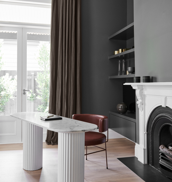 Grey study with a white fireplace and desk