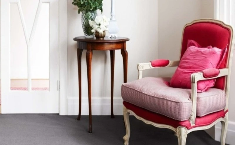 Cream living room with pink chair