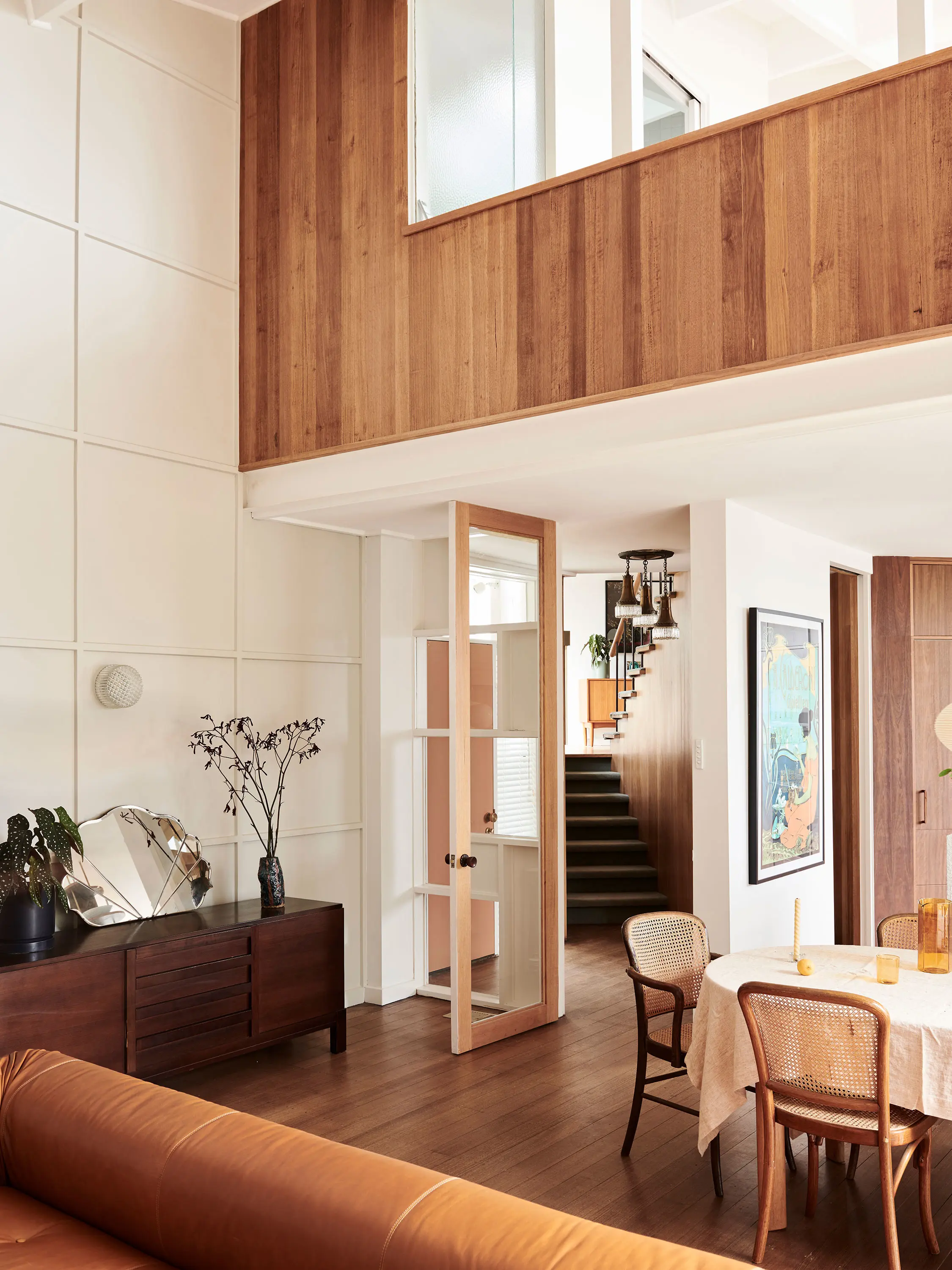 White living and dining room with timber accents.