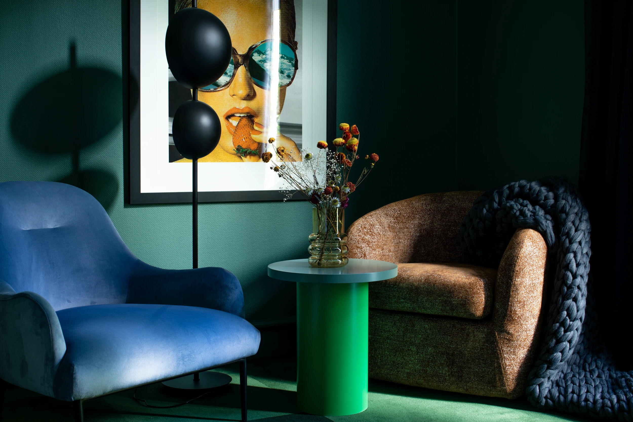 Blue armchair and brown armchair in green room