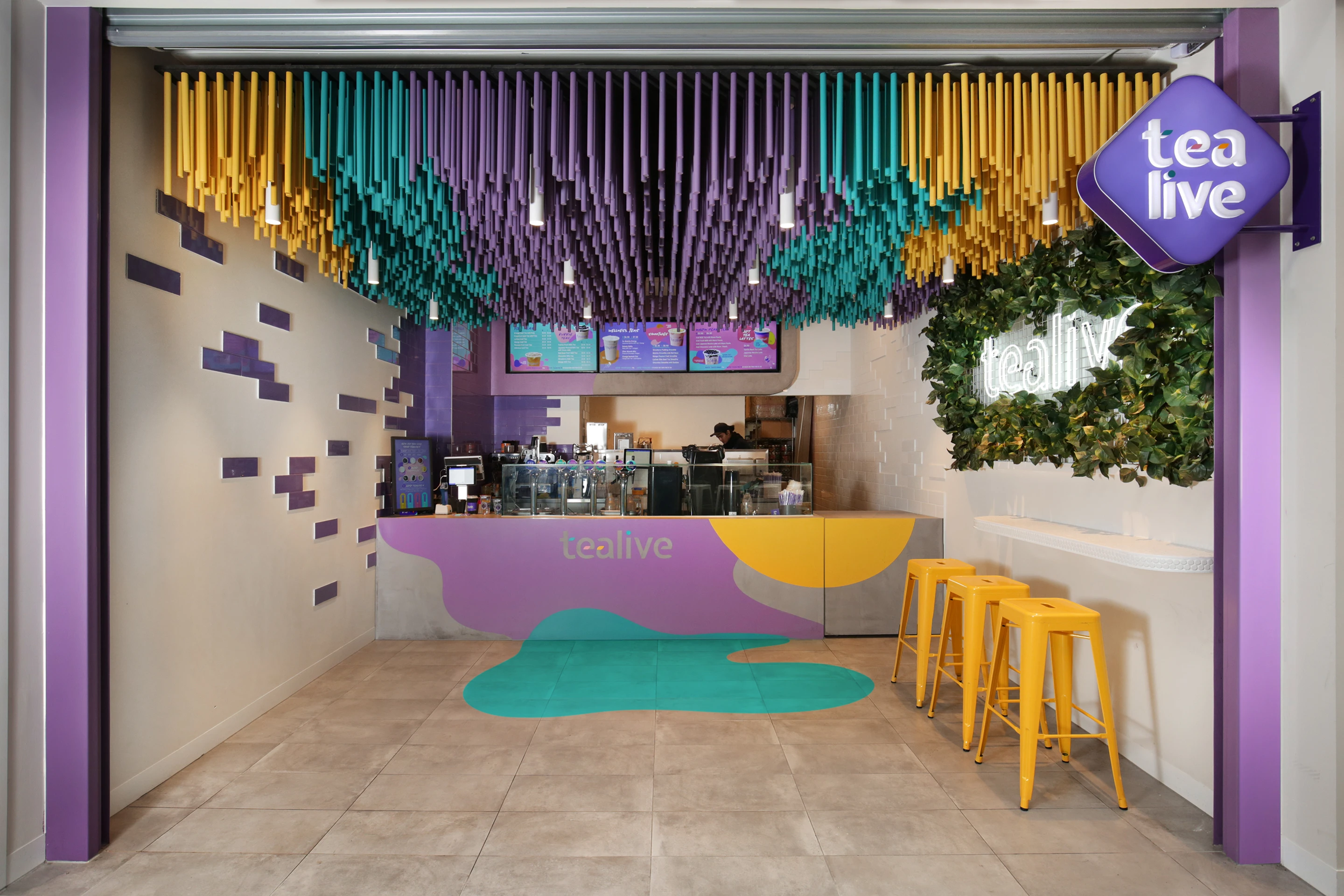 shop interior with yellow, teal and purple ceiling and bench