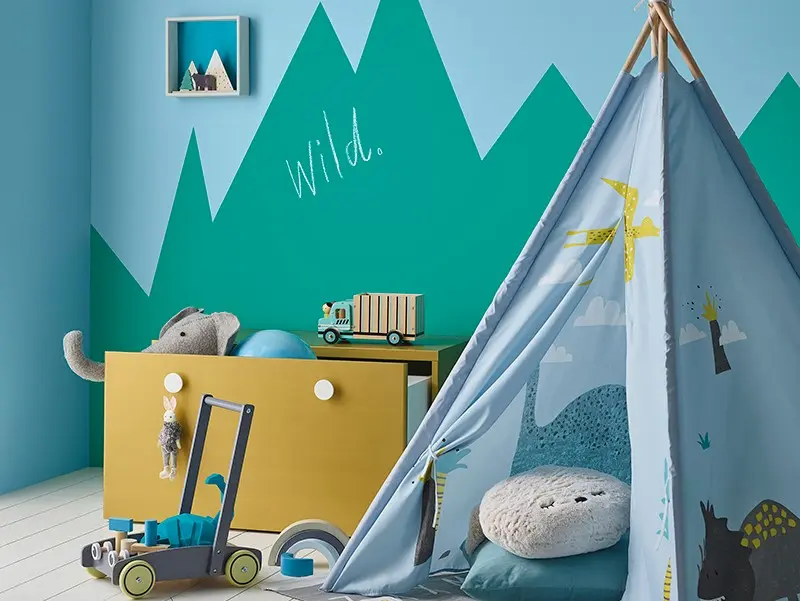 interior playroom with blue tent and yellow draws. 