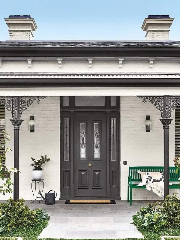 Black front door on white brick house